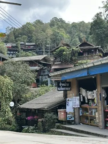 Mae Kampong village houses and local shop, motorcycle stop in Northern Thailand